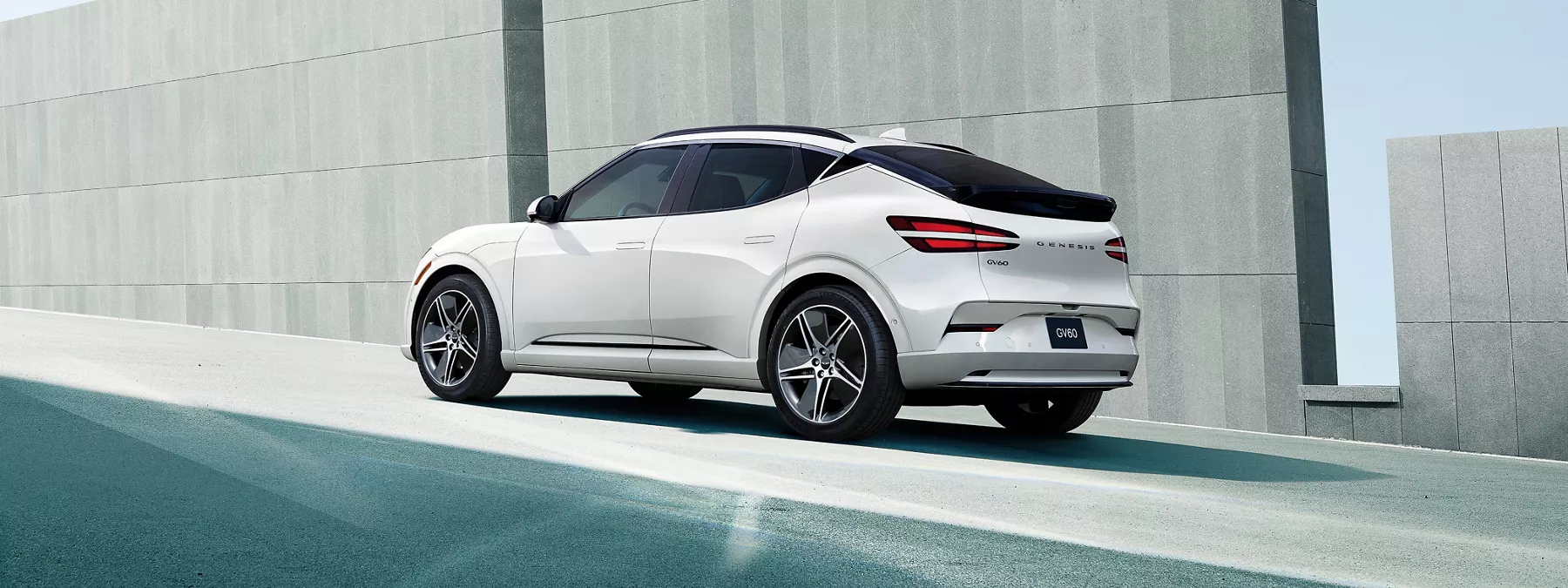 Exterior 3 4 Rear Driver Side View Of 2026 Genesis Gv60 In White Parked B